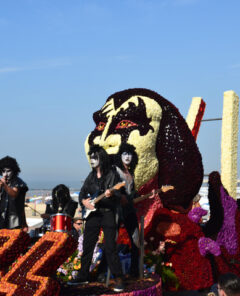 Blankenberge, West Flanders/ Belgium - August 25, 2019:: Beach festivity  flower corso, in Flemish called "Bloemencorso".Cortege of most original, beautiful riding  flower floats along beach dyke and streets. In this photo Group Kiss band Wonderland Dendermonde.