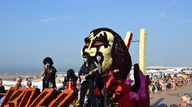 Blankenberge, West Flanders/ Belgium - August 25, 2019:: Beach festivity  flower corso, in Flemish called "Bloemencorso".Cortege of most original, beautiful riding  flower floats along beach dyke and streets. In this photo Group Kiss band Wonderland Dendermonde.