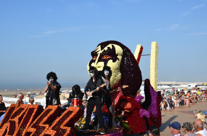 Blankenberge, West Flanders/ Belgium - August 25, 2019:: Beach festivity  flower corso, in Flemish called "Bloemencorso".Cortege of most original, beautiful riding  flower floats along beach dyke and streets. In this photo Group Kiss band Wonderland Dendermonde.