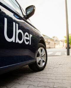 Warsaw, Poland  - April 30, 2019: View on Uber car (Skoda) with inscription on the street before sunset