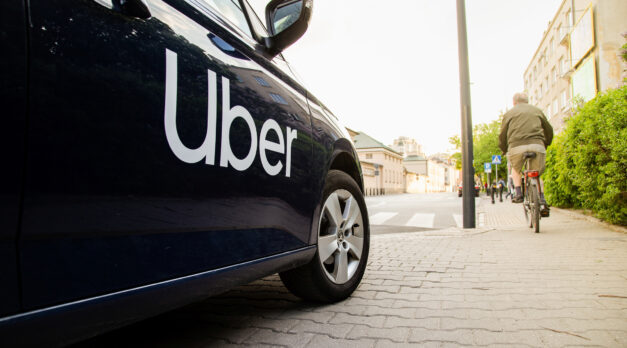 Warsaw, Poland  - April 30, 2019: View on Uber car (Skoda) with inscription on the street before sunset