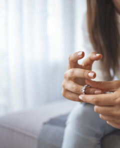 Unhappy woman holding wedding ring close up, upset girl crying, depressed with divorce, break up with boyfriend, broken engagement, feeling desperate, family split, bad relationships