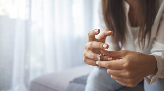 Unhappy woman holding wedding ring close up, upset girl crying, depressed with divorce, break up with boyfriend, broken engagement, feeling desperate, family split, bad relationships