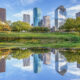 scenic skyline of Houston, Texas in morning light seen from Buffalo bayou park and reflection in river