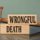 WRONGFUL DEATH - words on wooden blocks with a judge's gavel in the background