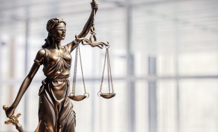 Legal and law concept statue of Lady Justice with scales of justice and office background