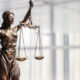 Legal and law concept statue of Lady Justice with scales of justice and office background