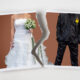 Divorce concept. Torn photograph of a couple at their wedding with red background